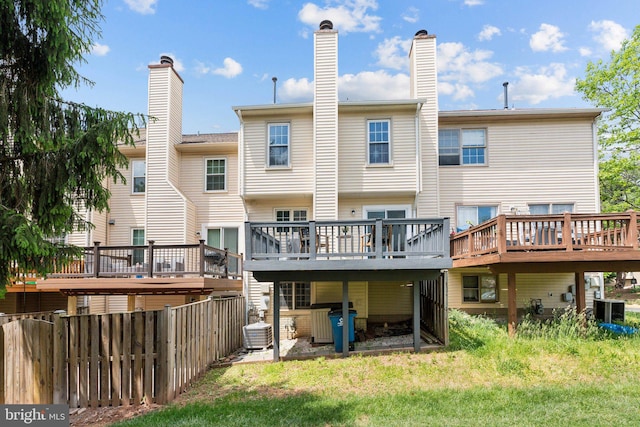 14724 Flower Hill Dr, Centreville, VA 20120 - back of house featuring a yard, cooling unit, a wooden deck, and fence