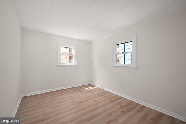 12505 Assawoman Dr, Ocean City, MD 21842 - spare room with baseboards, wood finished floors, a wealth of natural light, and ornamental molding