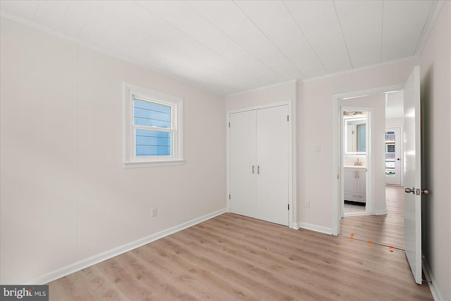 12505 Assawoman Dr, Ocean City, MD 21842 - unfurnished bedroom featuring light wood-type flooring, a closet, crown molding, and baseboards