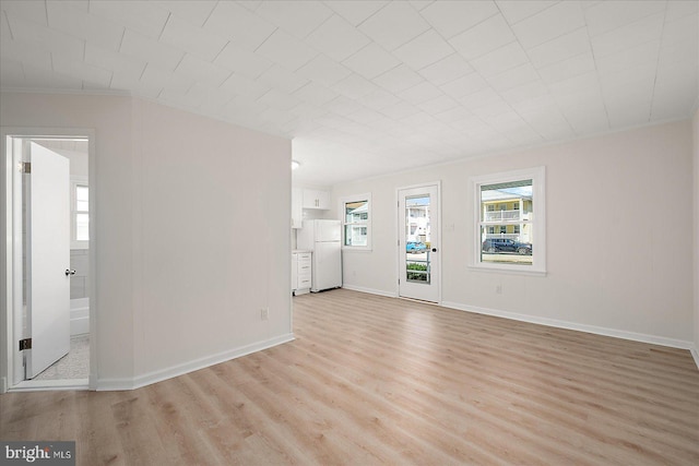 12505 Assawoman Dr, Ocean City, MD 21842 - unfurnished living room with baseboards, crown molding, and light wood finished floors