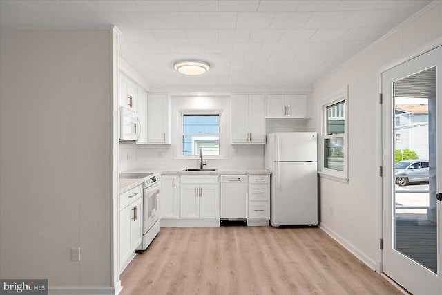 12505 Assawoman Dr, Ocean City, MD 21842 - kitchen featuring light wood-style flooring, a sink, white appliances, crown molding, and light countertops