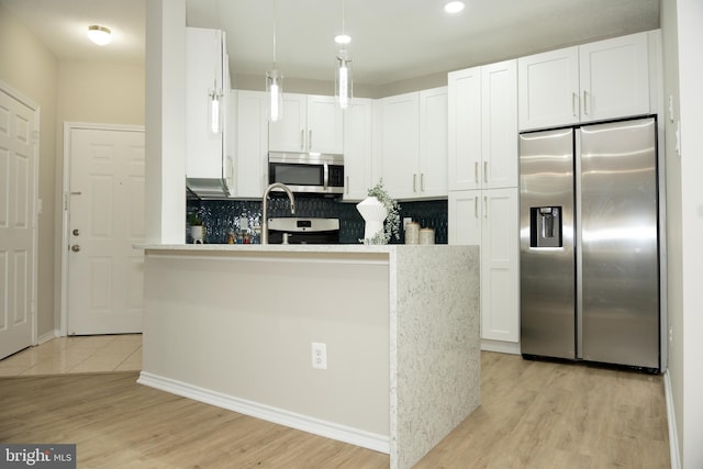 kitchen featuring light wood-style flooring, white cabinetry, and appliances with stainless steel finishes