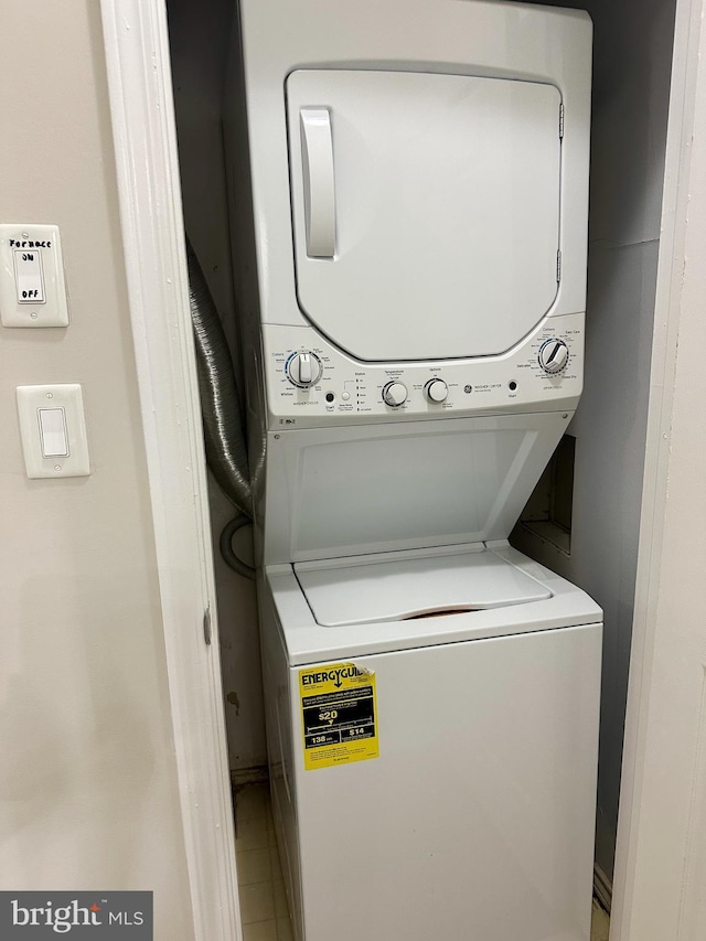 laundry area featuring stacked washer / dryer