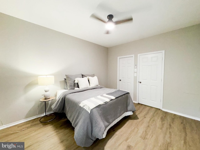 bedroom featuring baseboards, a ceiling fan, and wood finished floors