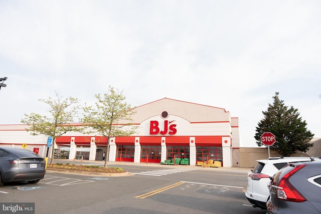 view of building exterior with uncovered parking
