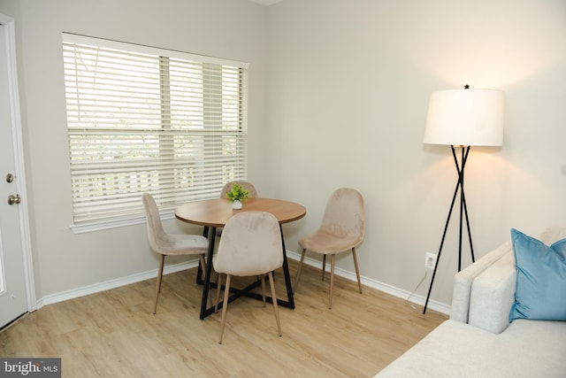 dining area featuring baseboards, a wealth of natural light, and light wood-style floors