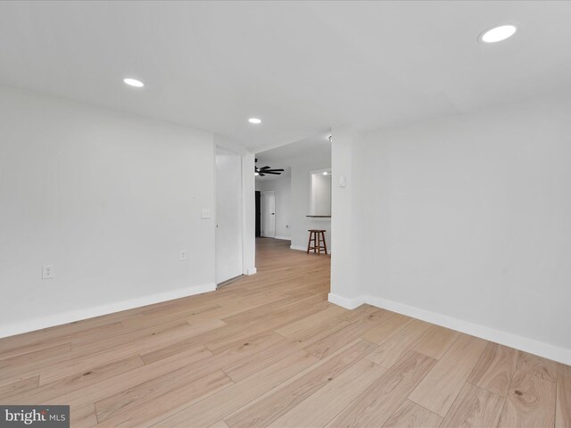 unfurnished room featuring baseboards, a ceiling fan, light wood finished floors, and recessed lighting