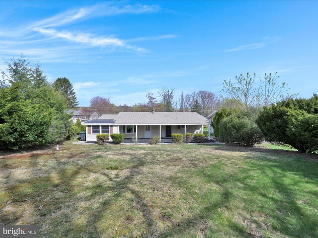 ranch-style home with a porch and a front yard