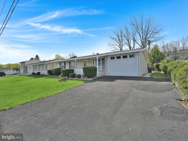 single story home with a front lawn, driveway, and a garage