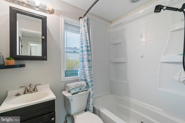 full bath with toilet, vanity, and shower / bath combo with shower curtain