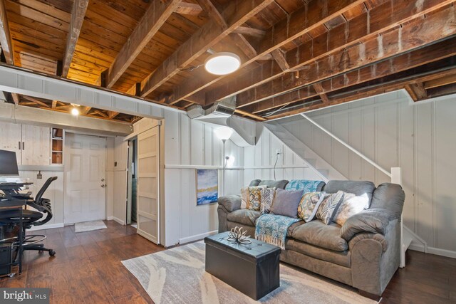 living room featuring beamed ceiling, dark wood finished floors, stairway, and wood ceiling