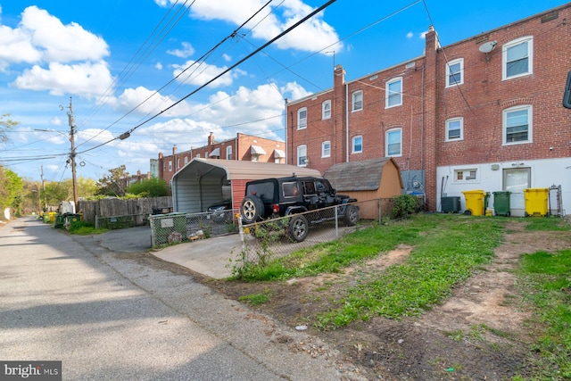 exterior space with fence and a carport