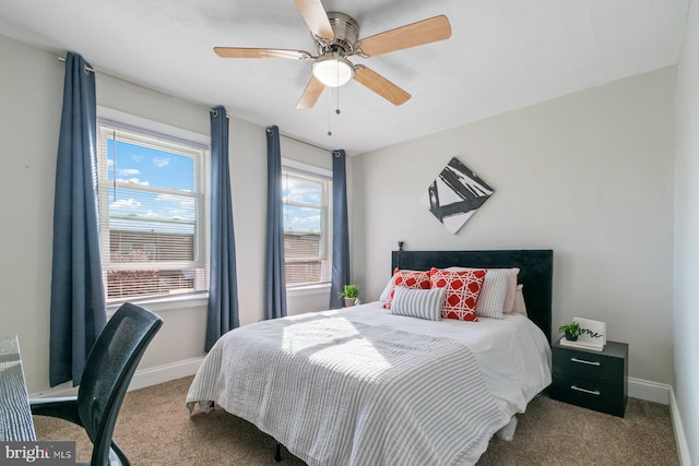 carpeted bedroom featuring baseboards and a ceiling fan