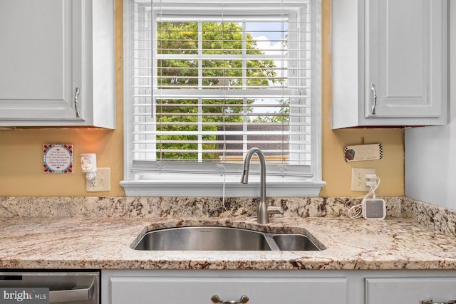 202 Stern Cv, Stafford, VA 22554 - kitchen view of a sink, stainless steel dishwasher, white cabinets, and light stone countertops