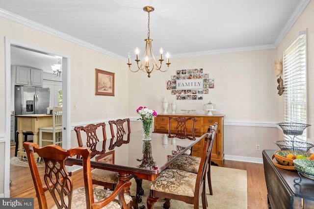 202 Stern Cv, Stafford, VA 22554 - dining area featuring a chandelier, wood finished floors, crown molding, and baseboards