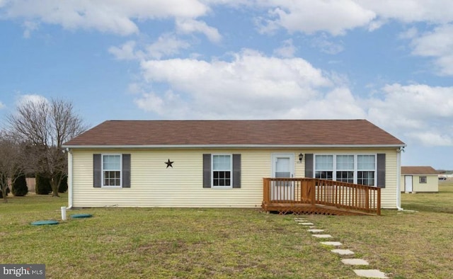 back of property featuring a lawn and a wooden deck