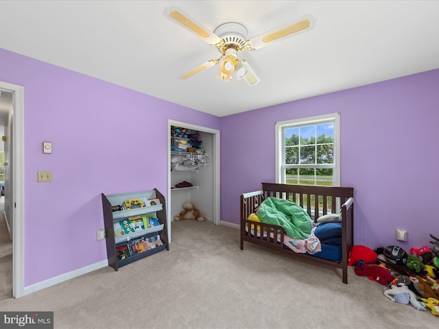 bedroom featuring ceiling fan, baseboards, carpet flooring, and a closet