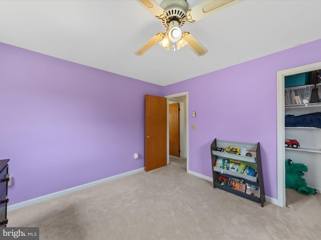 interior space featuring baseboards, ceiling fan, a closet, and carpet