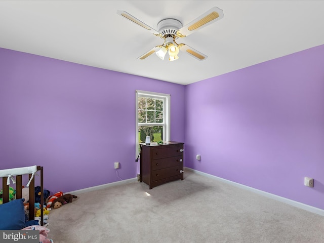 unfurnished bedroom with carpet, a ceiling fan, and baseboards