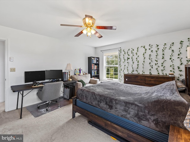 carpeted bedroom with a ceiling fan and baseboards