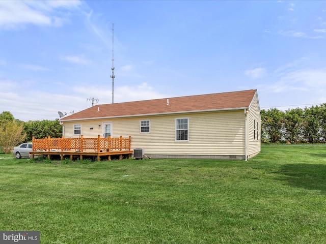 rear view of house featuring a deck, crawl space, cooling unit, and a lawn