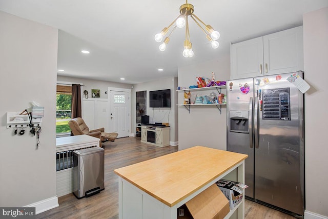 23745 Hicks Dr, Leonardtown, MD 20650 - kitchen with stainless steel fridge, a chandelier, light wood-style flooring, white cabinetry, and baseboards