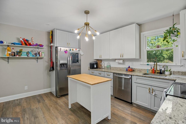 23745 Hicks Dr, Leonardtown, MD 20650 - kitchen featuring appliances with stainless steel finishes, a sink, wood finished floors, and a chandelier