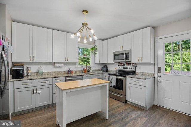 23745 Hicks Dr, Leonardtown, MD 20650 - kitchen featuring appliances with stainless steel finishes, a sink, a chandelier, butcher block countertops, and dark wood-style floors