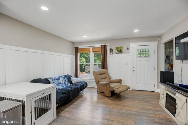 23745 Hicks Dr, Leonardtown, MD 20650 - living room featuring a decorative wall, wood finished floors, a wainscoted wall, and recessed lighting