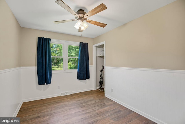 23745 Hicks Dr, Leonardtown, MD 20650 - unfurnished room featuring wood finished floors, ceiling fan, and a wainscoted wall