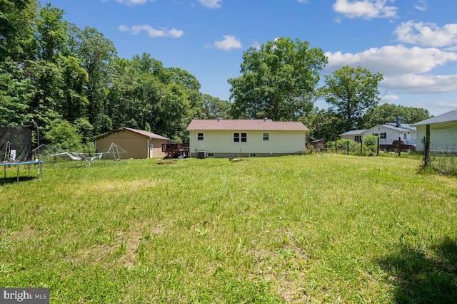 23745 Hicks Dr, Leonardtown, MD 20650 - view of yard with a trampoline, a wooden deck, and an outbuilding