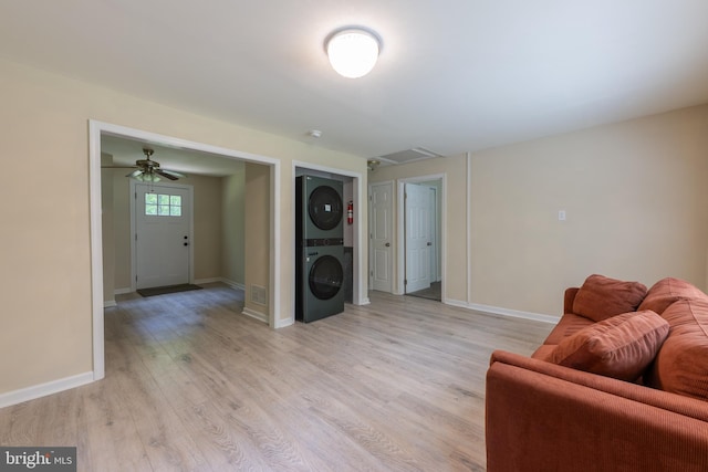 179 Mannington Yorketown Rd, Woodstown, NJ 08098 - living area featuring stacked washer and clothes dryer, light wood finished floors, baseboards, and ceiling fan