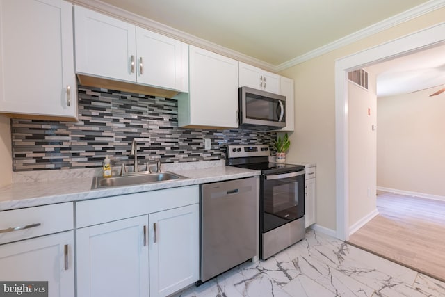 179 Mannington Yorketown Rd, Woodstown, NJ 08098 - kitchen featuring appliances with stainless steel finishes, a sink, crown molding, white cabinets, and light marble finish flooring