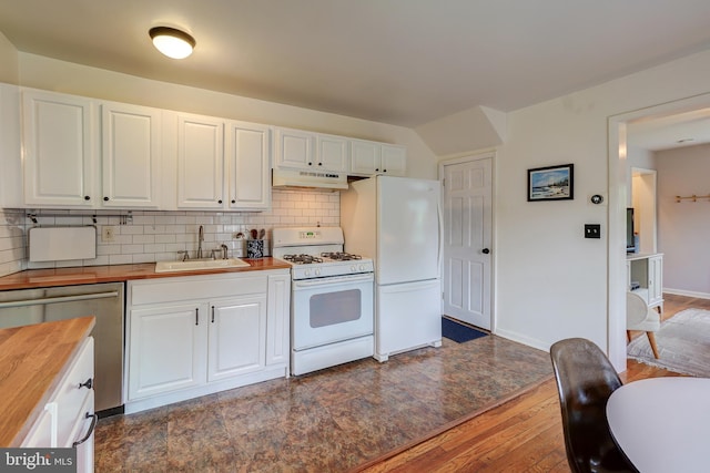 kitchen with white appliances, wooden counters, under cabinet range hood, a sink, and dark wood finished floors