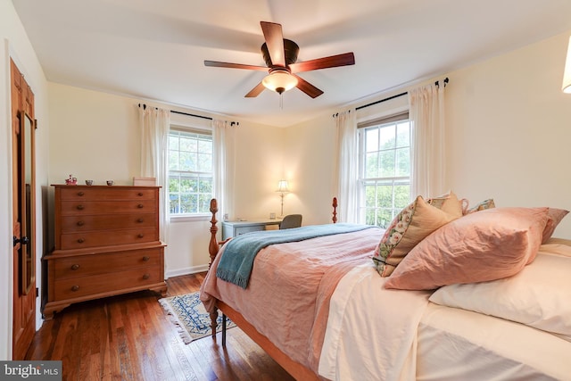 bedroom featuring hardwood / wood-style floors, baseboards, and ceiling fan