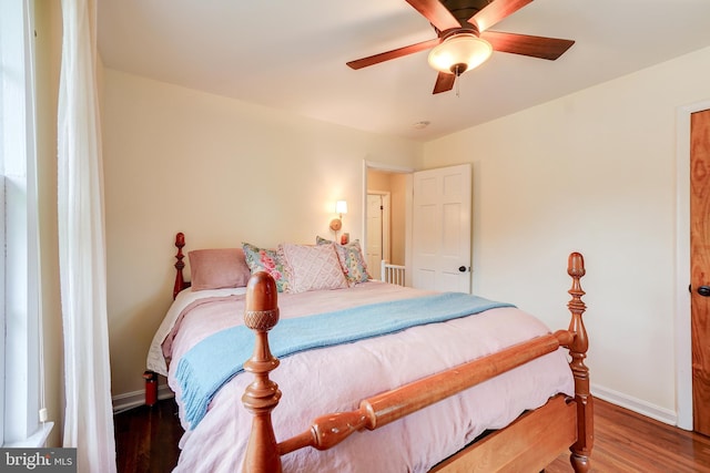 bedroom with baseboards, wood finished floors, and ceiling fan