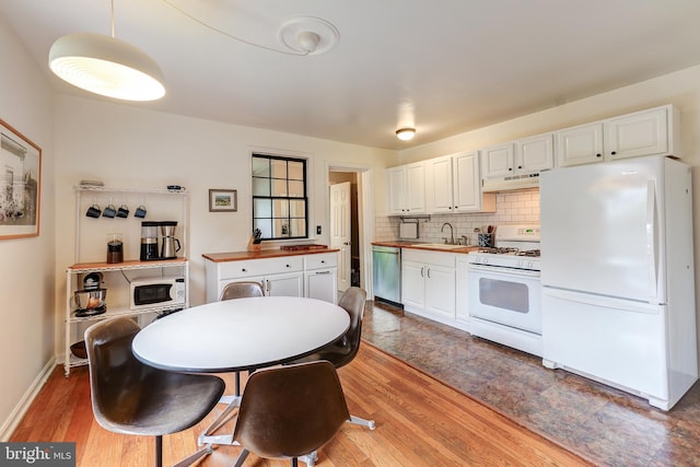 kitchen featuring white appliances, under cabinet range hood, wood counters, white cabinets, and light wood finished floors