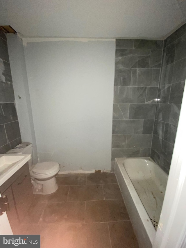 bathroom featuring tile walls, toilet, vanity, and tile patterned floors
