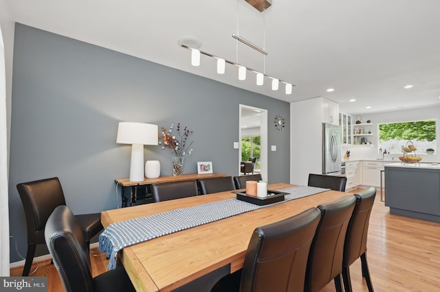 dining room featuring recessed lighting, track lighting, and light wood-style floors