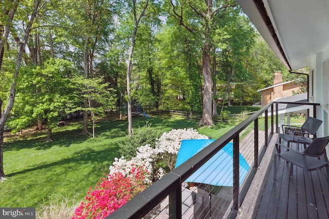wooden terrace with a yard