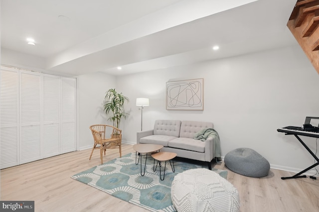 living area with baseboards, recessed lighting, and wood finished floors