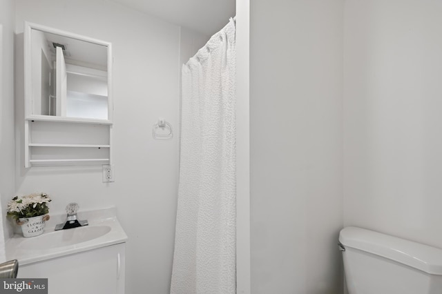 bathroom featuring vanity and toilet