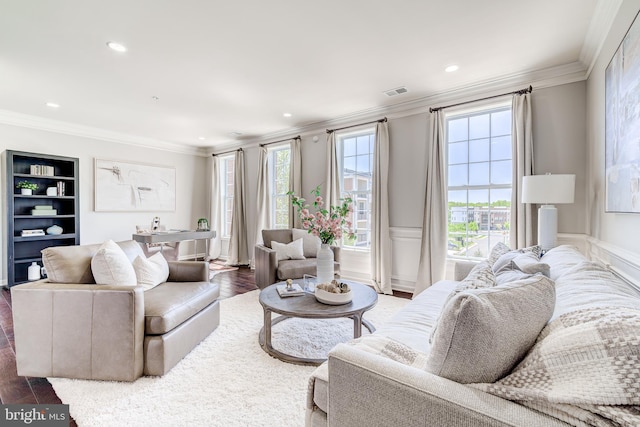 living area featuring crown molding, recessed lighting, and visible vents