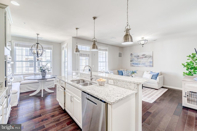 kitchen with open floor plan, a sink, dark wood-style flooring, and stainless steel appliances