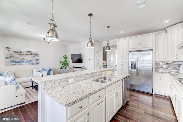 kitchen with stainless steel appliances, open floor plan, visible vents, and a sink