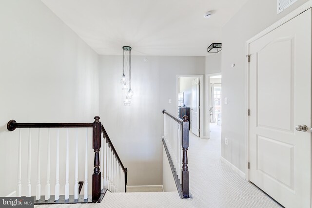 stairs featuring visible vents, carpet flooring, and baseboards