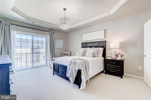 bedroom with visible vents, ornamental molding, a tray ceiling, and light carpet
