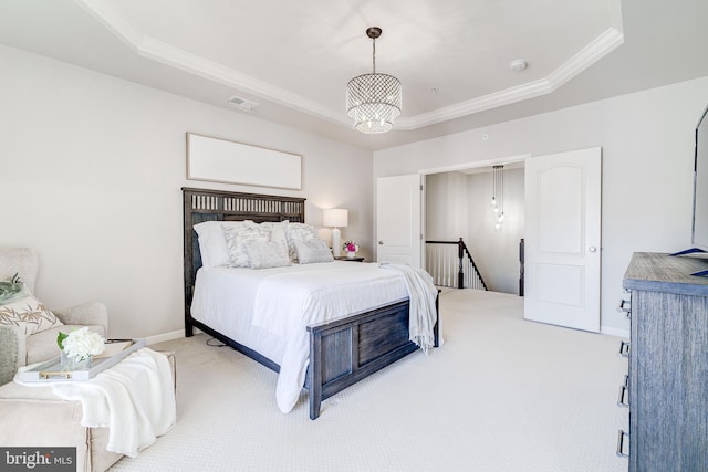 bedroom featuring light colored carpet, a raised ceiling, baseboards, visible vents, and ornamental molding