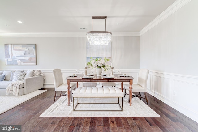dining room featuring an inviting chandelier, ornamental molding, wood finished floors, and visible vents