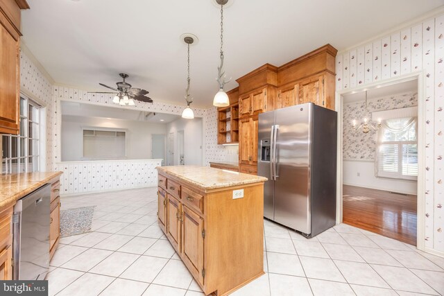 kitchen with appliances with stainless steel finishes, open shelves, wallpapered walls, and light tile patterned floors